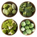 Green food on a white background. Brocoli, Roman cauliflower, squash and Brussels sprouts cabbage in a wooden bowl.