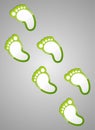 Green footprints on grey background.