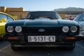 Green Ford Capri sports car parked outside