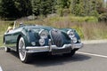 Green foreign vintage sports car with whitewall tires Royalty Free Stock Photo