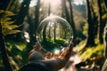 The green forest and sun light captured through a crystal lens ball. Generative AI