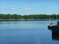 Lake shore summer landscape and fisherman in the Minsk Belarus blue sky background