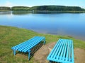 Lake shore summer landscape and bench blue sky background Royalty Free Stock Photo