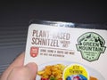 Green Fountain: Plant-Based Schnitzel in a Male Hand.
