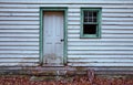 door and window of old clapboard hou