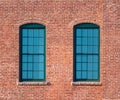 Green framed windows in a brick wall Royalty Free Stock Photo