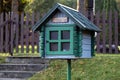 Green free book sharing mini house in nature Royalty Free Stock Photo