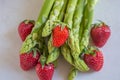 Green fresh asparagus with a bunch of healthy strawberries Royalty Free Stock Photo