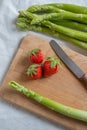 Green fresh asparagus with a bunch of healthy strawberries Royalty Free Stock Photo
