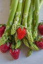 Green fresh asparagus with a bunch of healthy strawberries Royalty Free Stock Photo