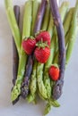 Green fresh asparagus with a bunch of healthy strawberries Royalty Free Stock Photo