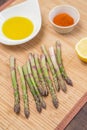 Green fresh asparagus for cooking on wooden table on kitchen close up. Healthy diet vegan food concept Royalty Free Stock Photo