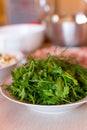 Green fresh bunch of parsley and dill lying on the plate for decoration of dishes Royalty Free Stock Photo