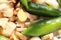 Green fresh chilli display with raw ginger cut pieces together with selective focus and daylight.