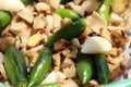 Green fresh chilli display with raw ginger cut pieces together with selective focus and daylight.