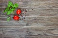 Green fresh leaves of organic basil and small ripe tomatoes salt and pepper on a wooden background Royalty Free Stock Photo