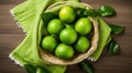 Green fresh limes on a straw small basket