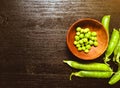 Green fresh peas in wooden plate Royalty Free Stock Photo