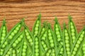 Green fresh peas on wooden texture close-up Royalty Free Stock Photo