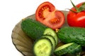 Green fresh sliced cucumber and tomato on glass plate Royalty Free Stock Photo