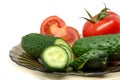 Green fresh sliced cucumber and tomato on glass plate Royalty Free Stock Photo