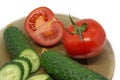 Green fresh sliced cucumber and tomato on glass plate Royalty Free Stock Photo