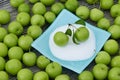 Green fresh sour plums and salt in the dish, sour plums with salt Royalty Free Stock Photo