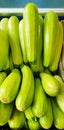 Green fresh squashes in a wooden box on the market street Royalty Free Stock Photo