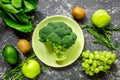 Green fresh vegetables and fruits for healthy salad on dark table background top view Royalty Free Stock Photo