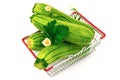 Green fresh zucchini with flowers and leaves in metal shopping basket. Isolated on white background Royalty Free Stock Photo