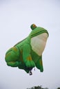 Green frog balloon taking off at international balloon festival Ballonfiesta