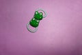 Green frog hair ties for little girls or toddlers isolated on purple background