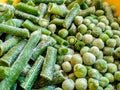 Green frozen beans and peas. Closeup frozen cut green french bean, haricot vert. Vegetable food background.