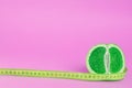 Green fruit with meter on pink Royalty Free Stock Photo