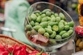 Green fruit vegetable melodii in a glass bowl. Ripe melothria is on the table