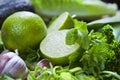 Green fruit and vegetable - wooden board with green food  ingredients: garlic, avocado, lime, mint, cilantro, leek, green chili Royalty Free Stock Photo