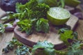 Green fruit and vegetable - wooden board with green food  ingredients: garlic, avocado, lime, mint, cilantro, leek, green chili Royalty Free Stock Photo