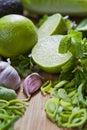 Green fruit and vegetable - wooden board with green food  ingredients: garlic, avocado, lime, mint, cilantro, leek, green chili Royalty Free Stock Photo