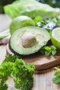 Green fruit and vegetable - wooden board with green food  ingredients: garlic, avocado, lime, mint, cilantro, leek, green chili Royalty Free Stock Photo