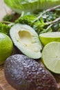 Green fruit and vegetable - wooden board with green food  ingredients: garlic, avocado, lime, mint, cilantro, leek, green chili Royalty Free Stock Photo