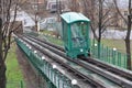 The green funicular trailer moves along the rails on the slope in Kyiv