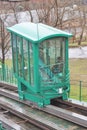 The green funicular trailer moves along the rails on the slope in Kyiv