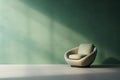Green futuristic armchair near the empty sage green wall with beautiful shadows. Minimalistic beige interior for mockups