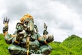 Green Ganesha Hindu God statue close up on natural background