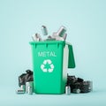 Green garbage bin with metal waste