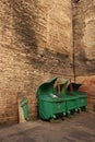 Green garbage bins at the brick wall in a courtyard in Saint-Petersburg, Russia.