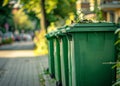 Green garbage bins in row on the street