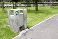 Green garbage can on a garden grass