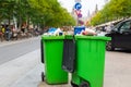 Green garbage can on sidewalk, european city Royalty Free Stock Photo