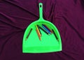 Green garbage cleaner with pencil isolated on black background Royalty Free Stock Photo